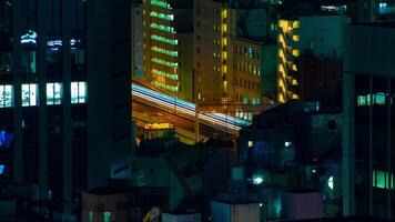 A night timelapse of highway at the urban city in Tokyo long shot tilt video