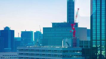 A timelapse of moving cranes at top of the building in Tokyo long shot video