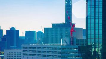 A timelapse of moving cranes at top of the building in Tokyo long shot video