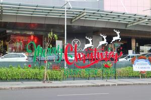 a merry Christmas decoration in front of tunjungan plaza. surabaya, indonesia - 21 february 2024 photo