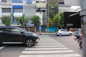 a view of zebracross for pedestrian to crossing the road. surabaya, indonesia - 21 february 2024 photo