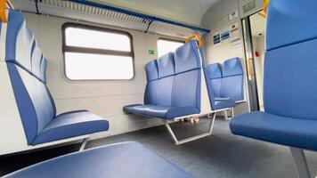 Moving train with empty seats or bench. Inside view, moving landscape out the windows, real time, no people. video