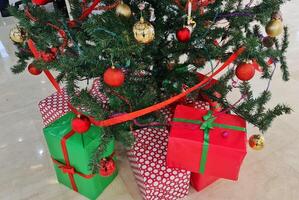 Pile gifts under the Christmas tree. Merry Christmas. Colorful gifts. photo