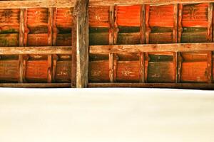 Clay roof tiles and rafters from a house tile in the village. photo