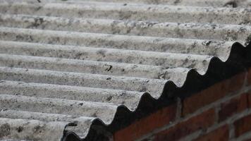 Asbestos roof tiles that have started to become ugly, originally gray in color are starting to show black spots. photo