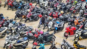 Bekasi, Indonesia on December 23 2023. Many motorized vehicles of various types fill the Bekasi Station parking lot. photo