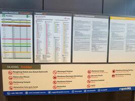 Kuala Lumpur, Malaysia on 21 May 2023. Information board regarding train schedule and fare from MRT Laluan Kajang. Conditions and restrictions photo