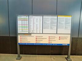 Kuala Lumpur, Malaysia on 21 May 2023. Information board regarding train schedule and fare from MRT Laluan Kajang. Conditions and restrictions photo