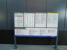 Kuala Lumpur, Malaysia on 21 May 2023. Information board regarding train schedule and fare from MRT Laluan Kajang. Conditions and restrictions photo