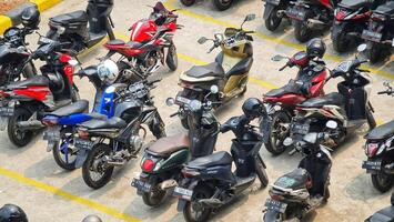 Bekasi, Indonesia on December 23 2023. Many motorized vehicles of various types fill the Bekasi Station parking lot. photo