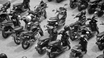 Bekasi, Indonesia on December 23 2023. Many motorized vehicles of various types fill the Bekasi Station parking lot. photo