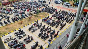 Bekasi, Indonesia on December 23 2023. Many motorized vehicles of various types fill the Bekasi Station parking lot. photo