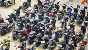 Bekasi, Indonesia on December 23 2023. Many motorized vehicles of various types fill the Bekasi Station parking lot. photo