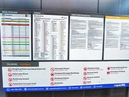 Kuala Lumpur, Malaysia on 21 May 2023. Information board regarding train schedule and fare from MRT Laluan Kajang. Conditions and restrictions photo