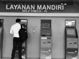 Jakarta, Indonesia on July 7 2022. Airplane passengers who are self-checking in at the machine available at Halim Perdanakusuma Airport. photo