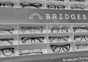 Bekasi, Indonesia on December 12 2023. Several glasses are neatly arranged in an glasses shop window. photo