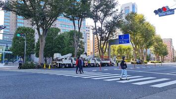 Tokyo, Japan on October 1, 2023. Several people are walking on a zebra cross. photo