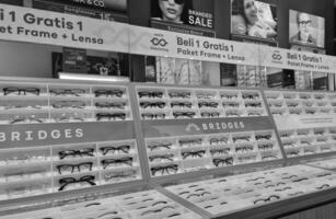 Bekasi, Indonesia on December 12 2023. Several glasses are neatly arranged in an glasses shop window. photo