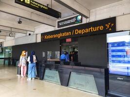 Jakarta, Indonesia on July 7 2022. The atmosphere from the departure entrance of Halim Perdanakusuma Airport, visible to passengers entering and officers on guard. There is also a self check for the photo
