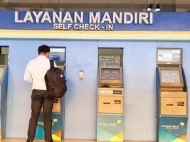 Jakarta, Indonesia on July 7 2022. Airplane passengers who are self-checking in at the machine available at Halim Perdanakusuma Airport. photo