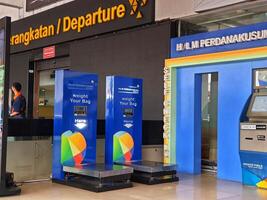 Jakarta, Indonesia on July 7 2022. The atmosphere from the departure entrance of Halim Perdanakusuma Airport, visible to passengers entering and officers on guard. There is also a self check photo