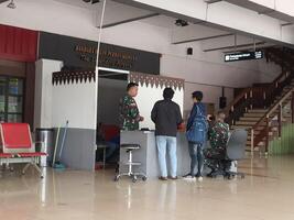 Jakarta, Indonesia on July 7 2022. The atmosphere from the departure entrance of Halim Perdanakusuma Airport, visible to passengers entering and officers on guard. There is also a self check photo