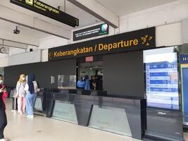 Jakarta, Indonesia on July 7 2022. The atmosphere from the departure entrance of Halim Perdanakusuma Airport, visible to passengers entering and officers on guard. There is also a self check for the photo