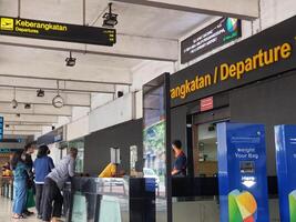 Jakarta, Indonesia on July 7 2022. The atmosphere from the departure entrance of Halim Perdanakusuma Airport, visible to passengers entering and officers on guard. There is also a self check for the photo