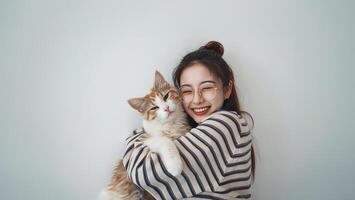 Glasses-wearing woman, pet embrace, striped outfit photo