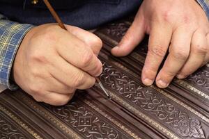 Bookbinder makes a unique cover for book. Handmake leather bookcover. photo