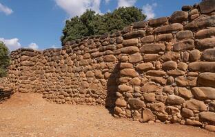 Old stone wall, ancient masonry. Defensive wall. Landscape, historical plot. Natural background photo