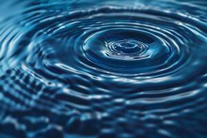 Perfect Droplet Creating Ripples in Blue Water photo