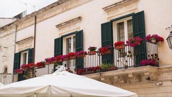 Balconies filled with purple flowers photo