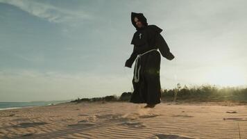 Monk Does Jump Rope Sport Training On The Sand Dunes photo