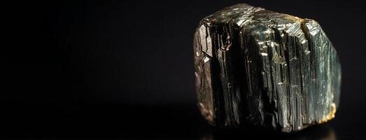 Enargite is a rare precious natural stone on a black background. . Header banner mockup with space. photo