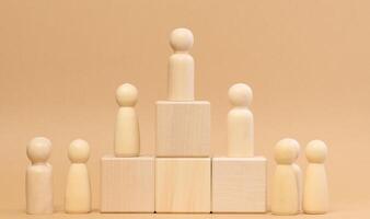 Wooden figures of men stand on a pedestal. The concept of rivalry in sports, business and life. Achieving success photo