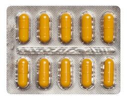 Oval yellow tablets in white plastic packaging photo