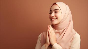 European woman wearing scarf is praying and smiling on brown background photo