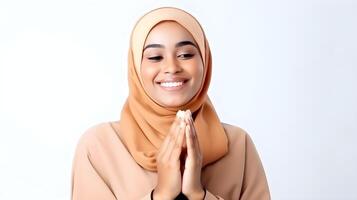 African woman wearing scarf is praying and smiling on white background photo