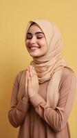 europeo mujer vistiendo bufanda es Orando y sonriente en marrón antecedentes foto