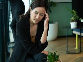 Female woman lady girl businesswoman suit person people human worried problem anxious business stress indoor office copy space siting work job occupation unhappy depresses manager nervous serious tire photo