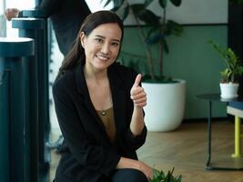 Businesswoman female lady person people human beautiful pretty look at camera happy smile thumb up cheerful copy space gesture office indoor professional attractive like ok job work pretty executive photo