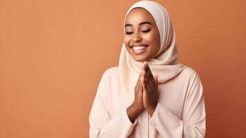 African woman wearing scarf is praying and smiling on red background photo