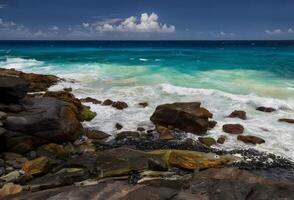 a rocky shoreline with waves crashing against the rocks photo