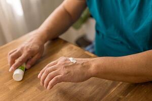 skin care, hands smeared with cream on dark background photo