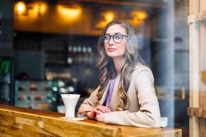 Business Woman Sitting Cafe Behind Window Waiting Business Partner photo