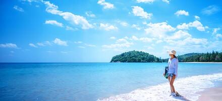 Asian woman travel nature. Travel relax. Walking on the beach. In the summer photo