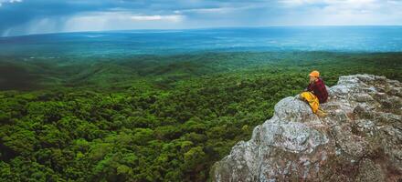 woman asians travel relax in the holiday. View mountain nature on the cliffs. photo