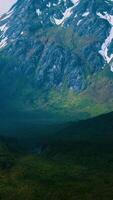 Aerial Over Valley With Snow Capped Mountains In Distance video