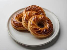 Freshly baked buns on a white plate on a white background photo